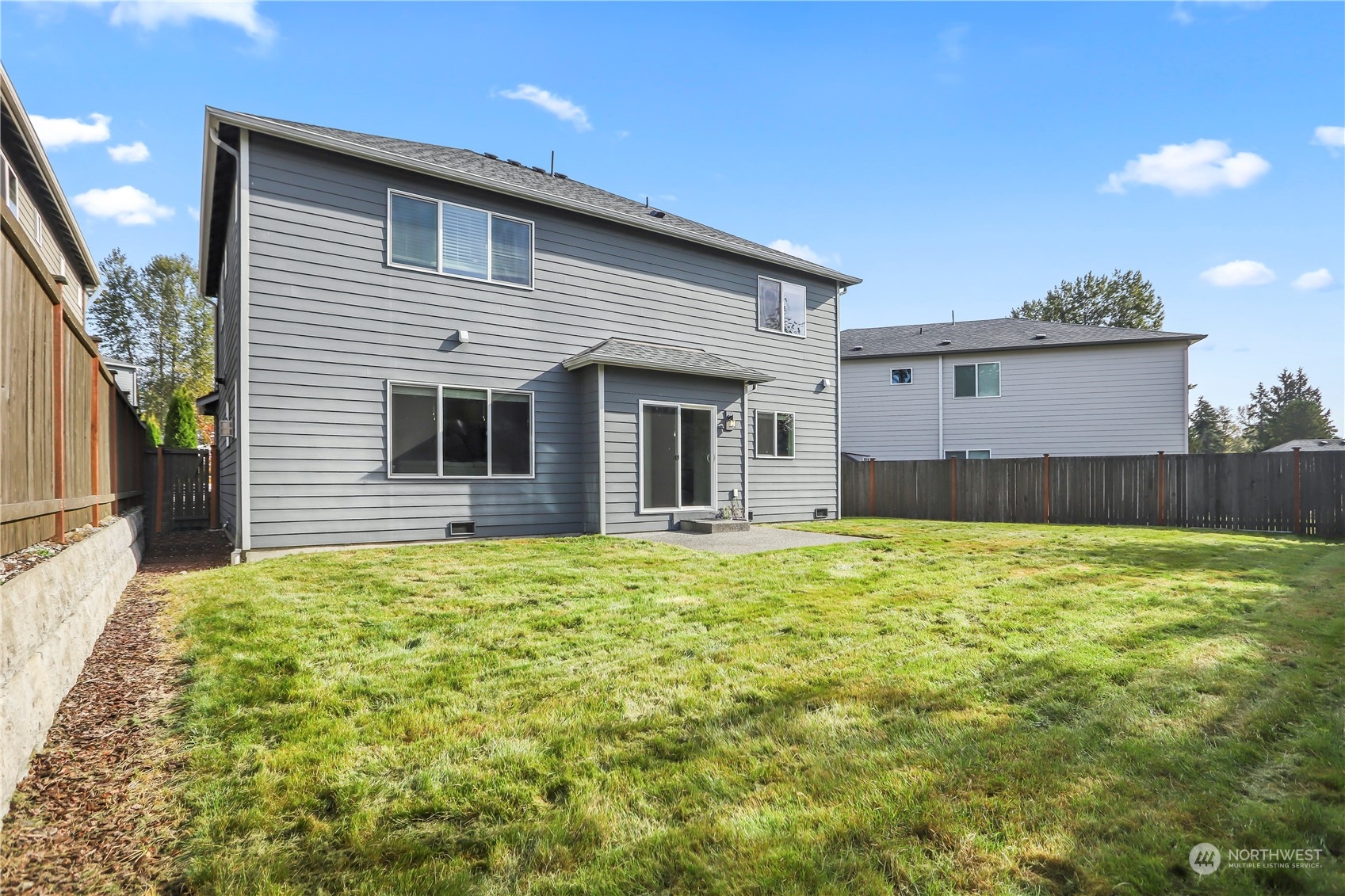1224 198th Place Southeast Bothell, WA 98012 - Photo 29 of 38 a backyard of a house with large trees and plants