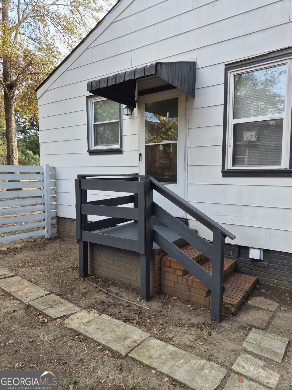 2241 Bruce Avenue Columbus, GA 31903 - Photo 2 of 15 a view of a wooden bench in the backyard