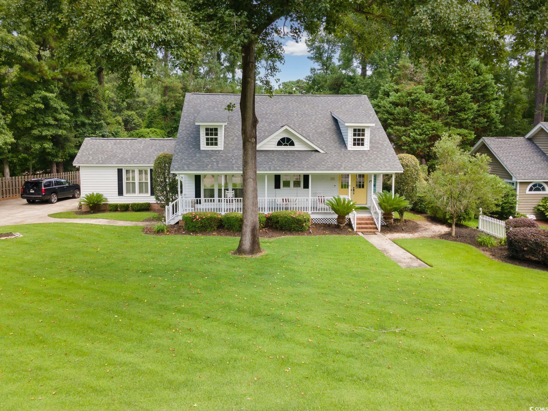 33 Great Lakes Road Pawleys Island, SC 29585 - Photo 1 of 30 Lowcountry home featuring covered porch and a fron