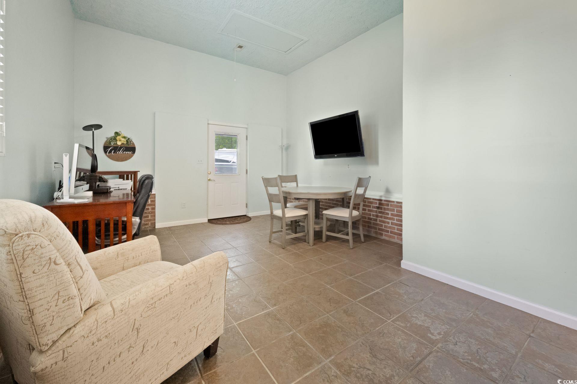 33 Great Lakes Road Pawleys Island, SC 29585 - Photo 12 of 30 Tiled living room featuring a textured ceiling and