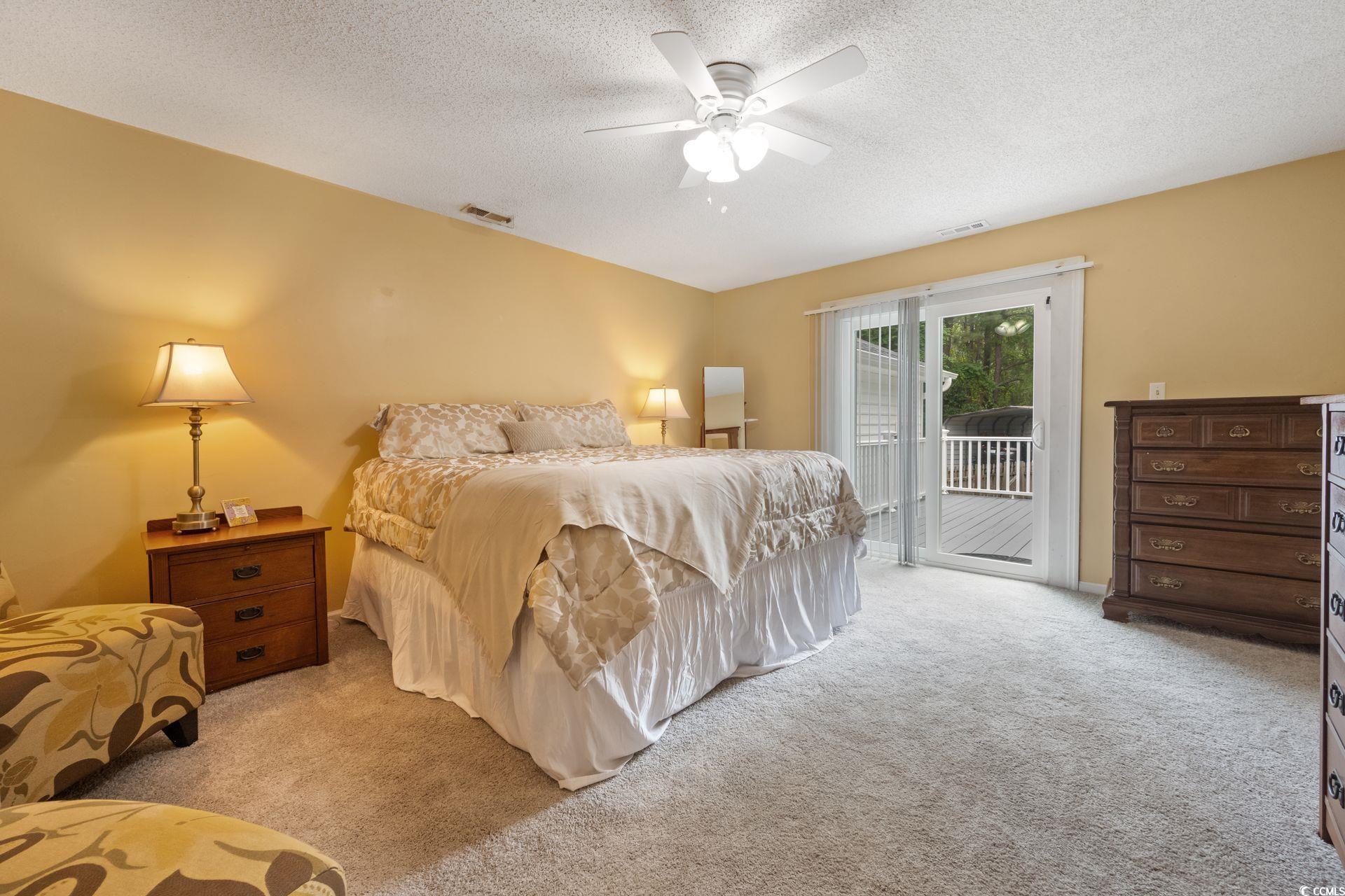 33 Great Lakes Road Pawleys Island, SC 29585 - Photo 14 of 30 Carpeted bedroom with access to outside, a texture