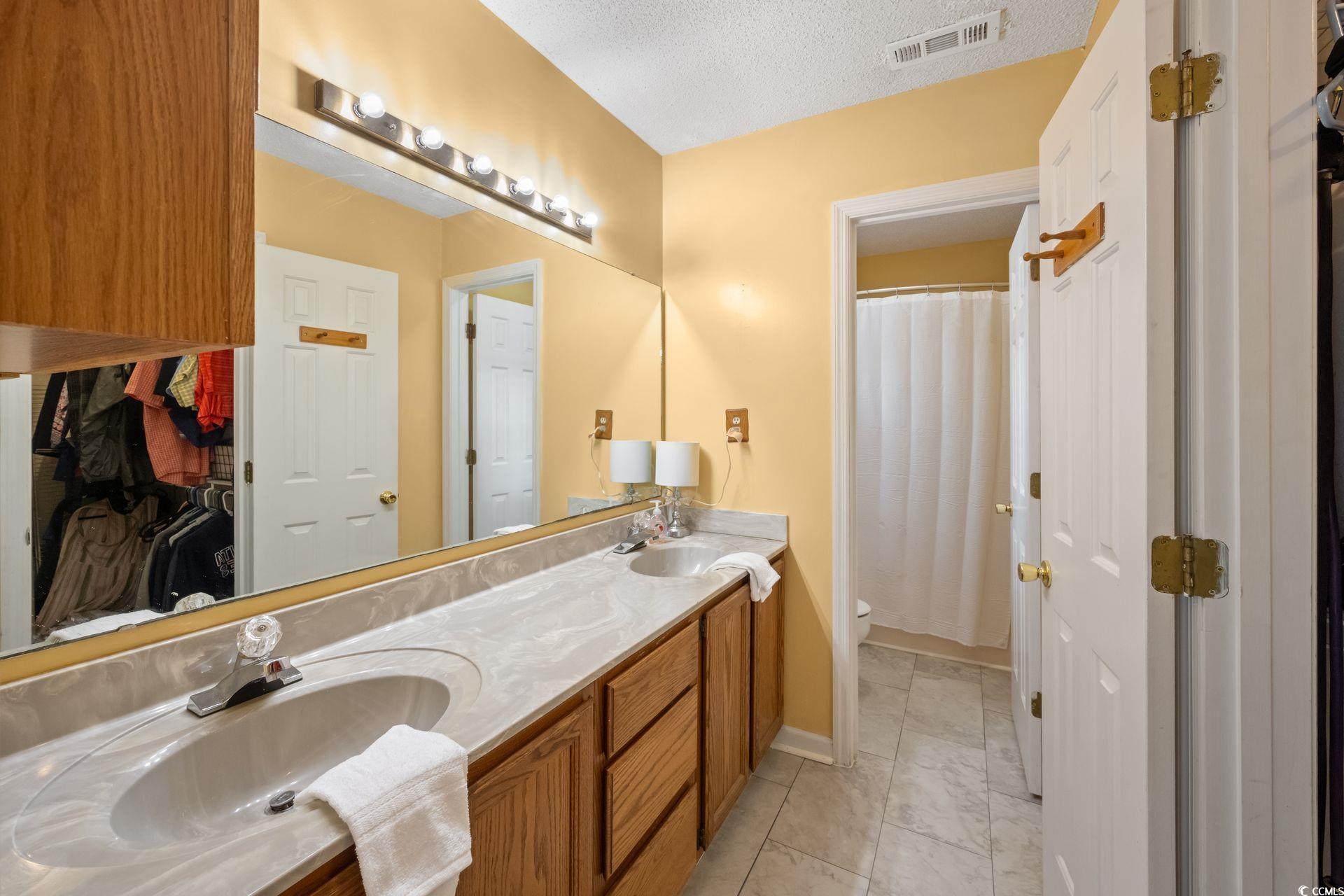 33 Great Lakes Road Pawleys Island, SC 29585 - Photo 16 of 30 Bathroom with toilet, tile patterned floors, a tex