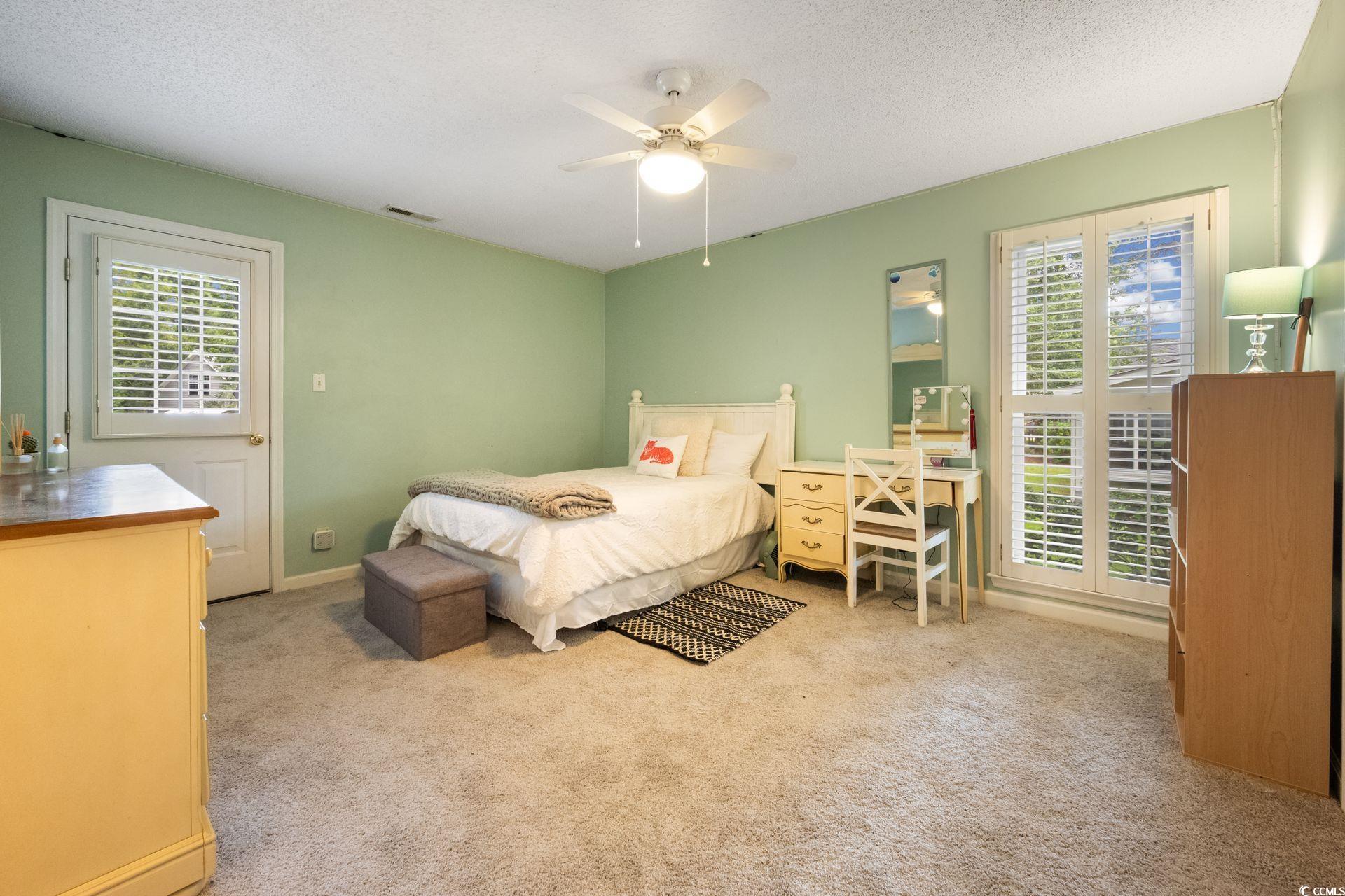 33 Great Lakes Road Pawleys Island, SC 29585 - Photo 17 of 30 Carpeted bedroom featuring multiple windows, a tex