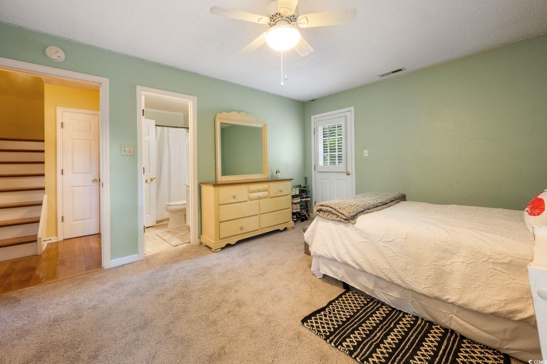 33 Great Lakes Road Pawleys Island, SC 29585 - Photo 18 of 30 Carpeted bedroom with a textured ceiling, ensuite