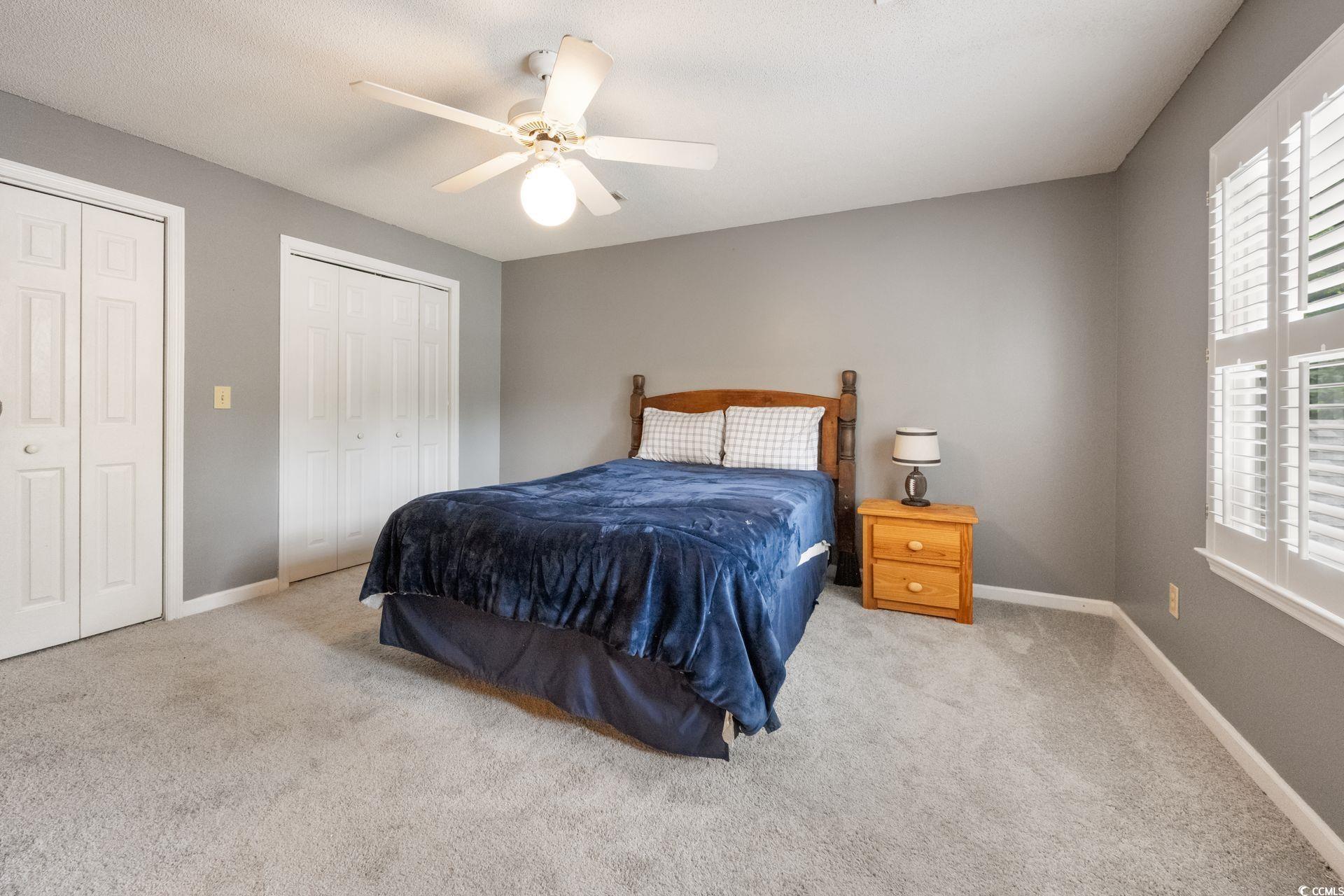 33 Great Lakes Road Pawleys Island, SC 29585 - Photo 19 of 30 Bedroom featuring two closets, light colored carpe