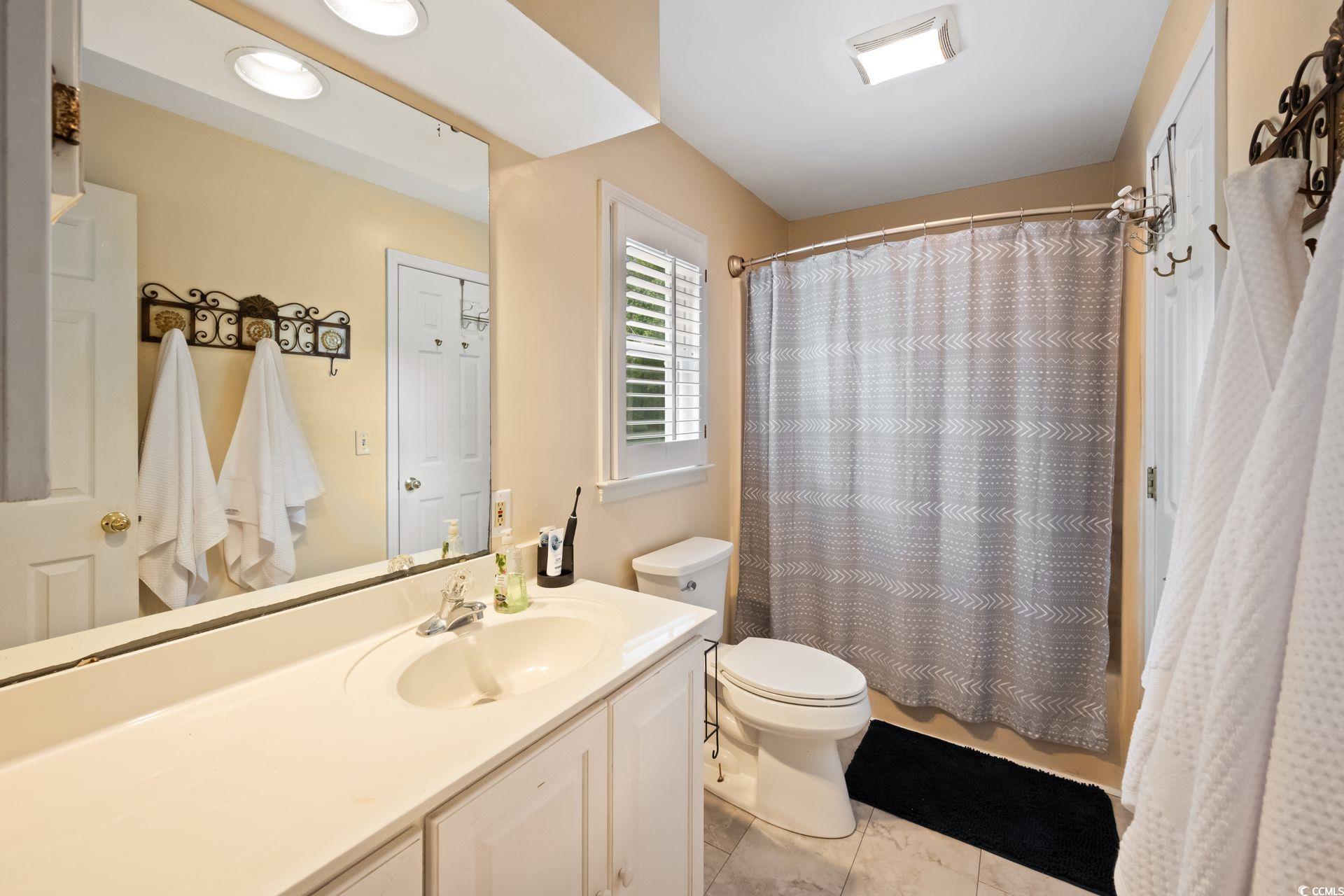 33 Great Lakes Road Pawleys Island, SC 29585 - Photo 20 of 30 Bathroom with vanity, tile patterned flooring, and
