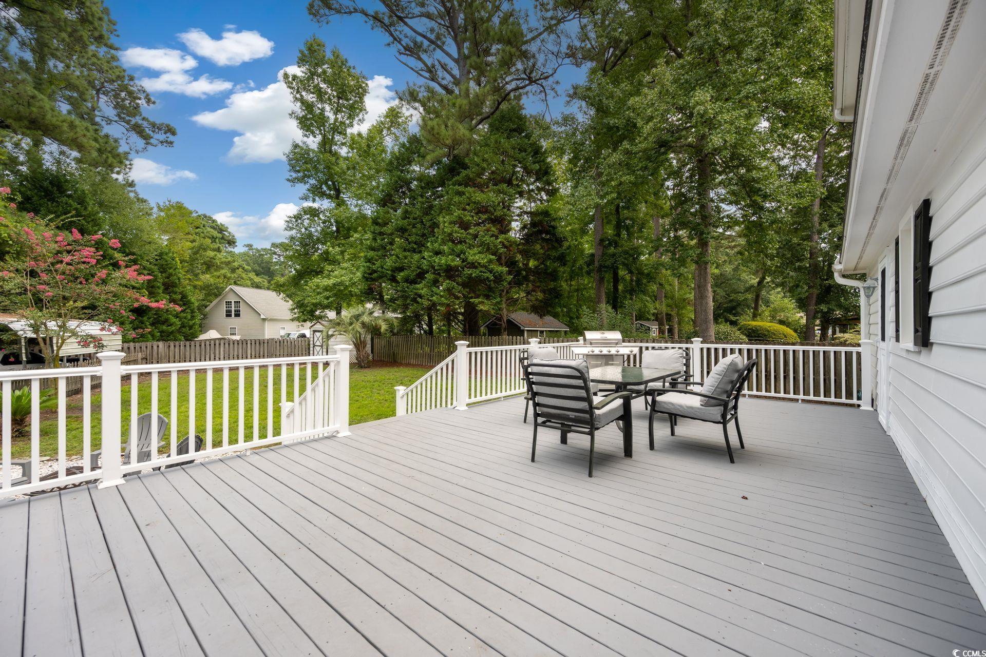 33 Great Lakes Road Pawleys Island, SC 29585 - Photo 23 of 30 Wooden deck featuring a yard and a storage unit