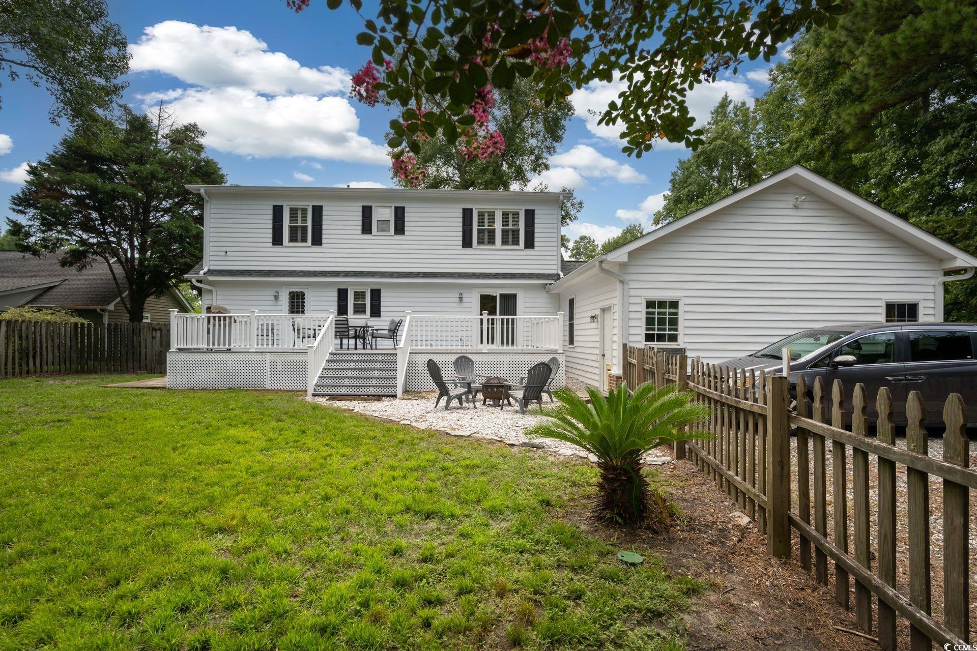 33 Great Lakes Road Pawleys Island, SC 29585 - Photo 26 of 30 Back of house with a yard and a wooden deck