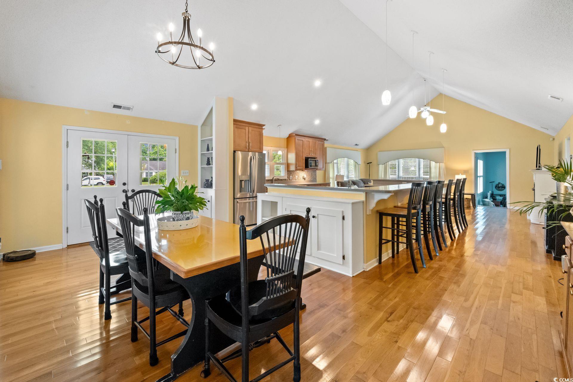 33 Great Lakes Road Pawleys Island, SC 29585 - Photo 6 of 30 Dining area featuring high vaulted ceiling, light