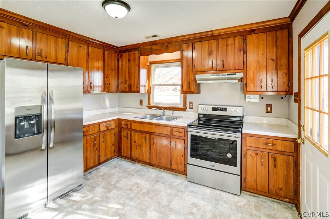 26 Jackson Road Bumpass, VA 23024 - Photo 10 of 36 a kitchen with stainless steel appliances granite countertop a stove a sink dishwasher a refrigerator and cabinets with wooden floor