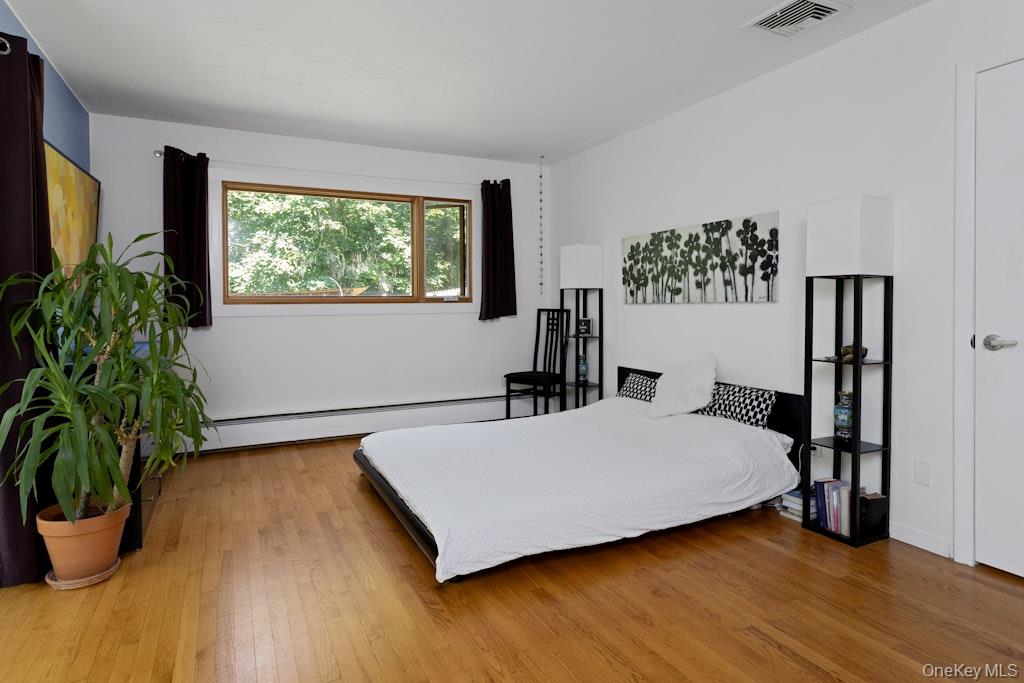 2 Buttermilk Falls Road Nyack, NY 10960 - Photo 18 of 41 a bedroom with a bed and a potted plant
