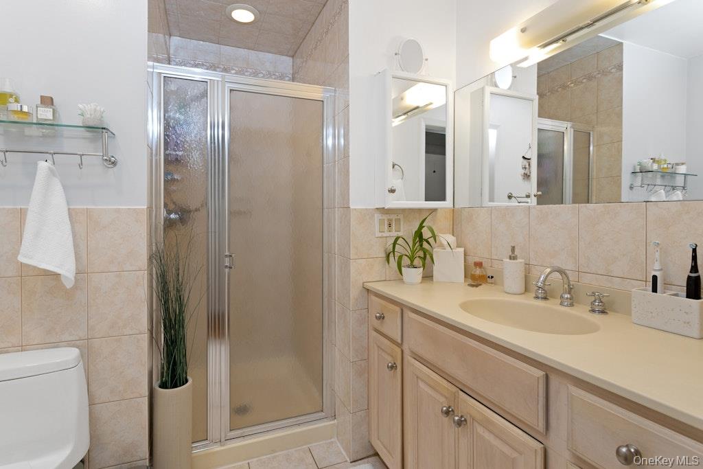 2 Buttermilk Falls Road Nyack, NY 10960 - Photo 20 of 41 a bathroom with a shower sink vanity and mirror