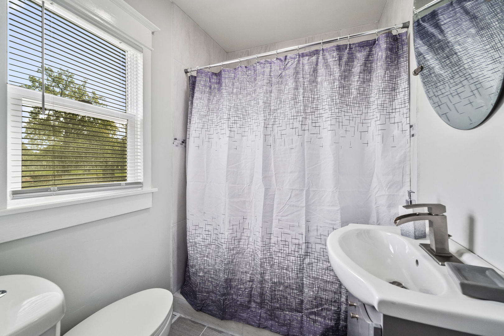 303 Princeton Street Lockport, IL 60441 - Photo 11 of 16 a bathroom with a sink a toilet and a mirror