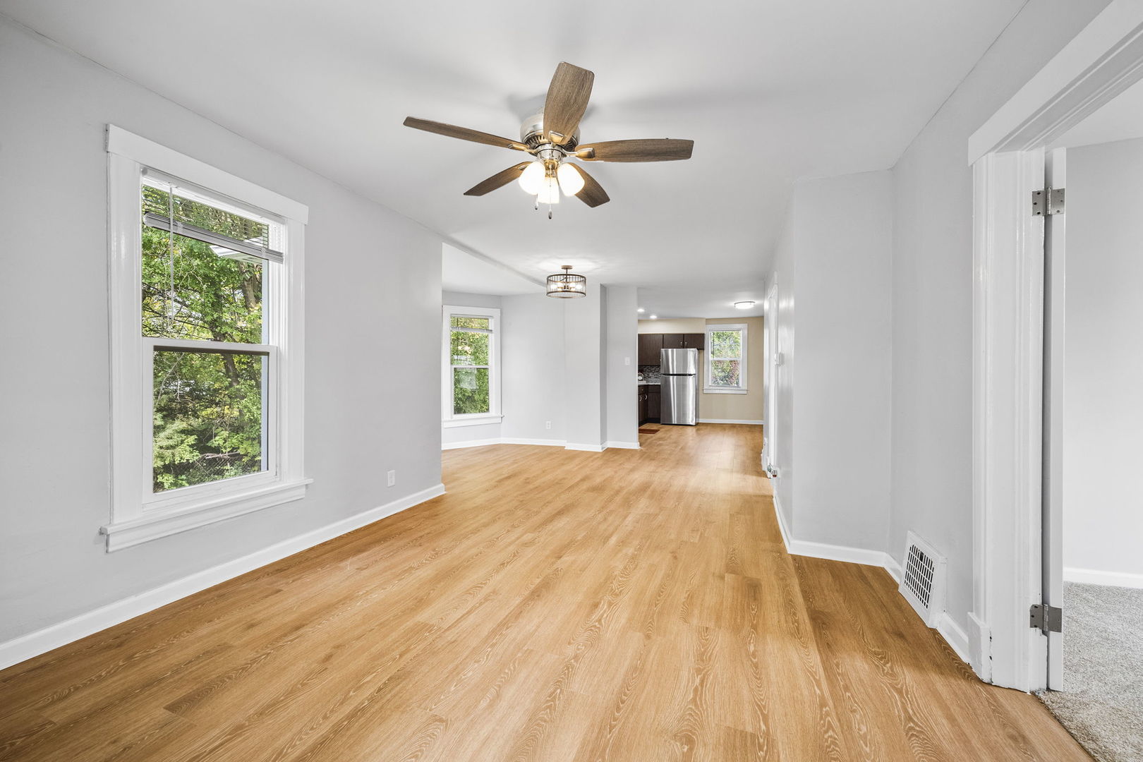 303 Princeton Street Lockport, IL 60441 - Photo 3 of 16 a view of empty room with wooden floor and fan
