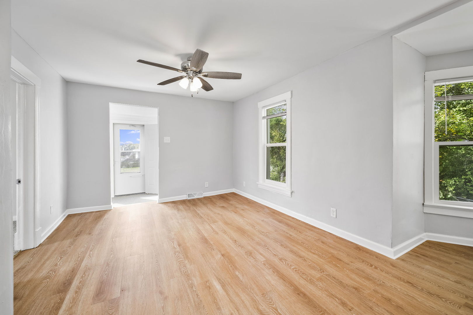 303 Princeton Street Lockport, IL 60441 - Photo 4 of 16 a view of empty room with wooden floor and fan