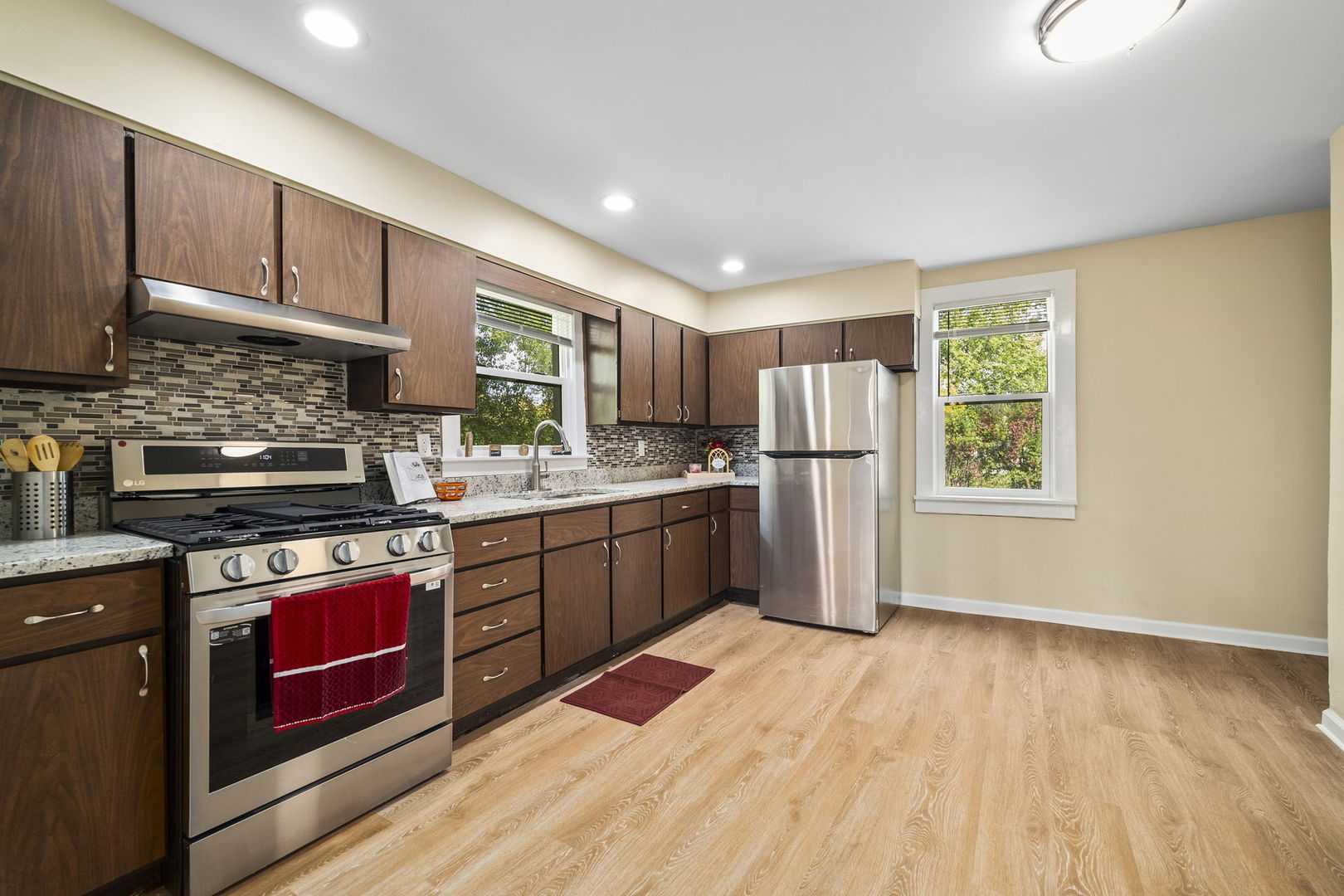 303 Princeton Street Lockport, IL 60441 - Photo 7 of 16 a kitchen with stainless steel appliances granite countertop a refrigerator sink and stove