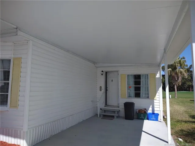 a view of a house with backyard and porch