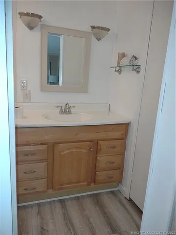 a bathroom with a sink vanity and mirror