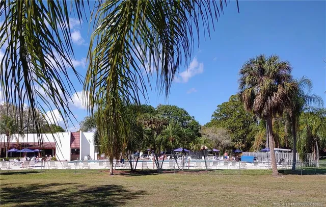 a view of a swimming pool with a table and chairs