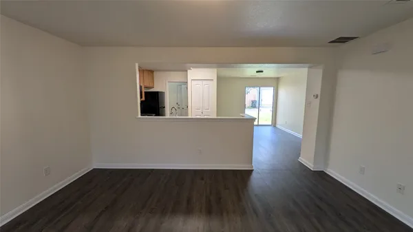 wooden floor in a hall with an empty room and wooden floor