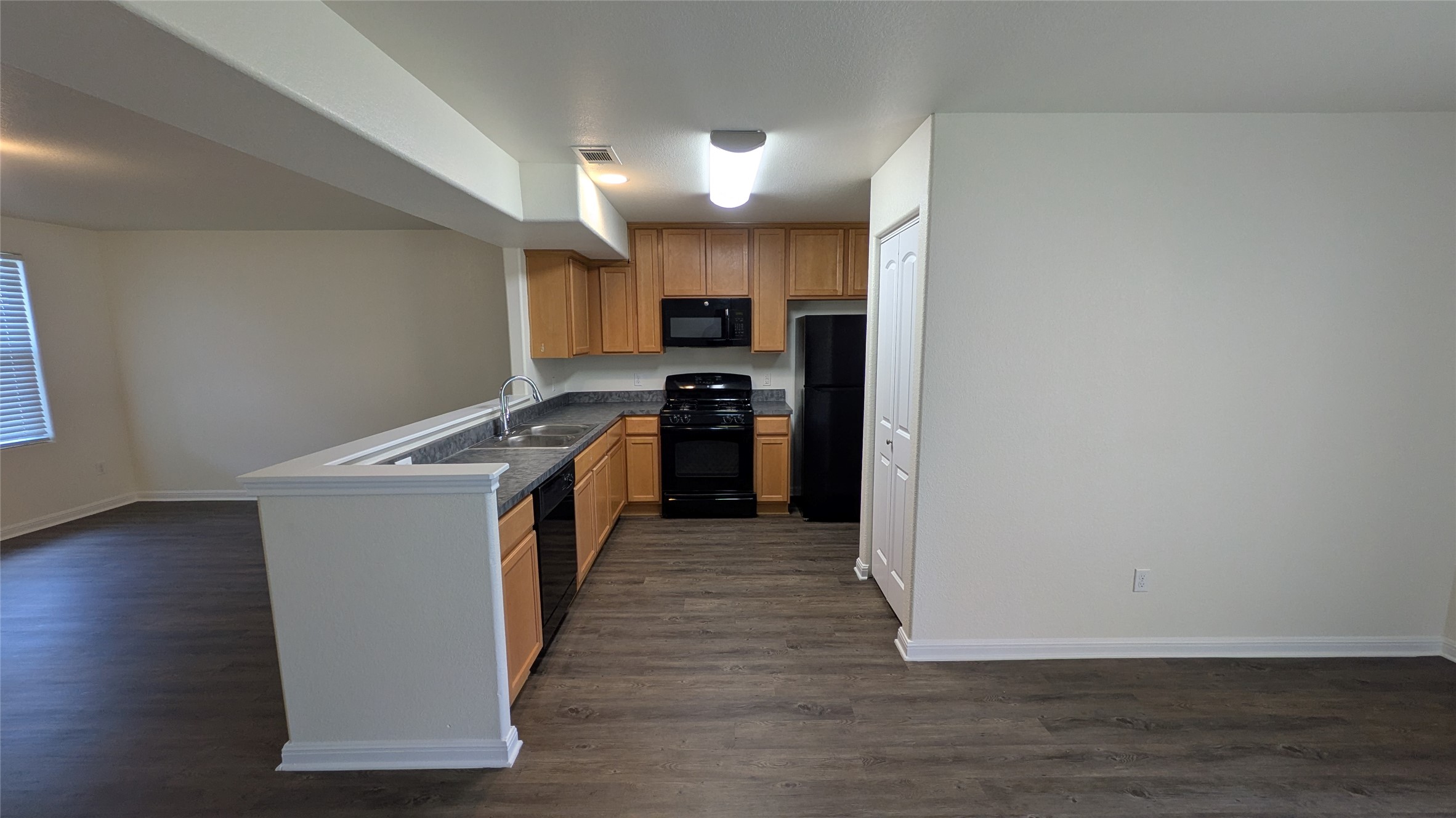 262 Trestle Tree San Marcos, TX 78666 - Photo 5 of 18 a view of a kitchen with a sink and a refrigerator