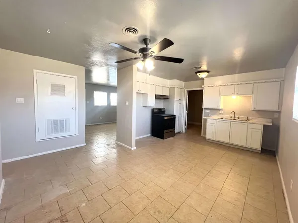 a view of a kitchen with furniture and a ceiling fan