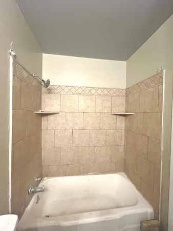 a bathroom with a bathtub and shower