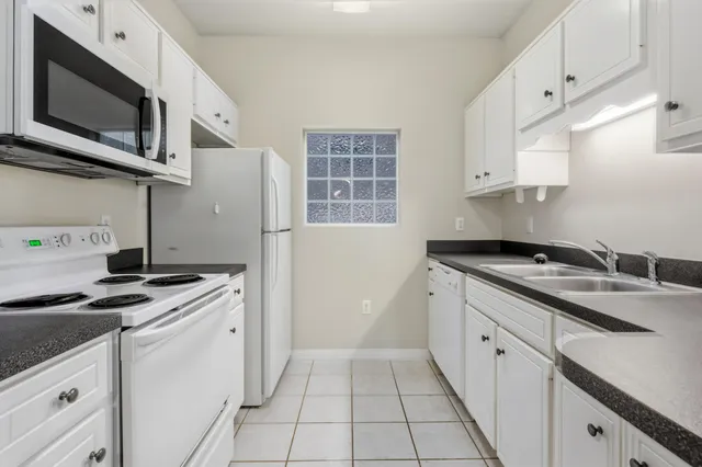 a kitchen with stainless steel appliances a stove microwave and cabinets