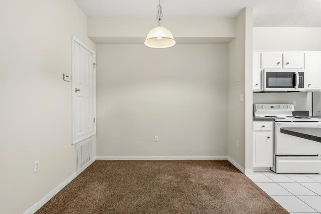 a kitchen with a refrigerator and a stove top oven