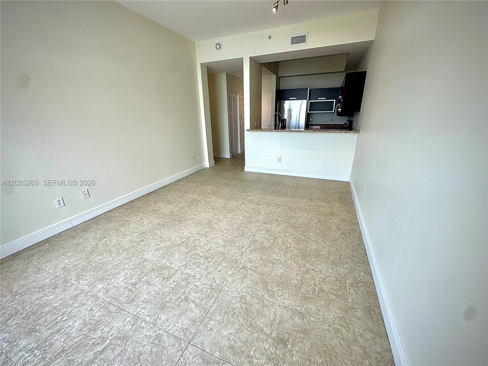2525 Southwest 3rd Avenue, Unit 705 Miami, FL 33129 - Photo 7 of 26 a view of a hallway to an empty room and fire place