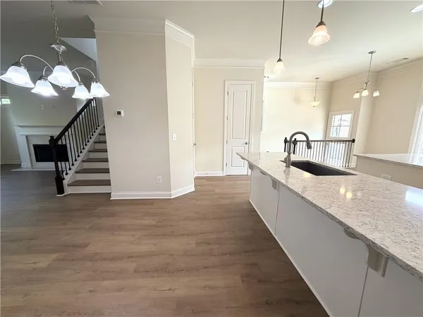 a large kitchen with kitchen island a sink stainless steel appliances and a counter top space