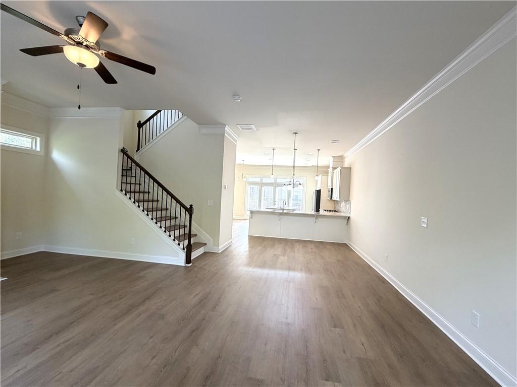 1980 Raven Way Chamblee, GA 30341 - Photo 13 of 51 an empty room with wooden floor fan and windows