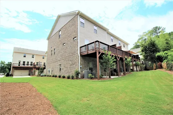 a view of a house with a yard and sitting area