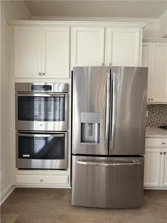 a kitchen with appliances and cabinets