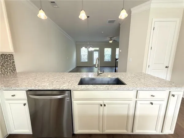 a bathroom with a granite countertop sink a mirror and a vanity