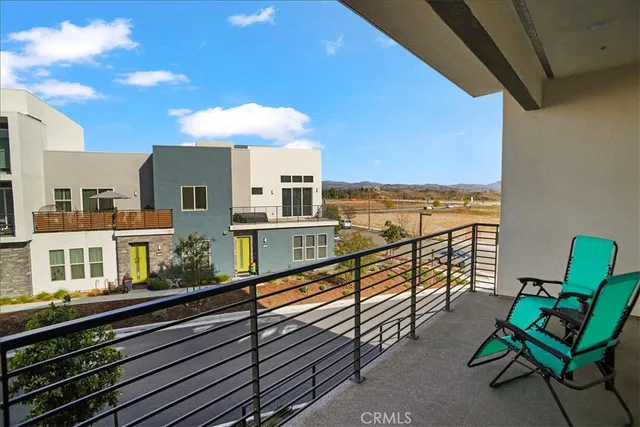 a view of a balcony with chairs