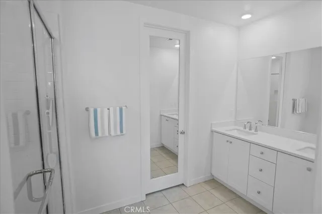 a bathroom with a double vanity sink and mirror