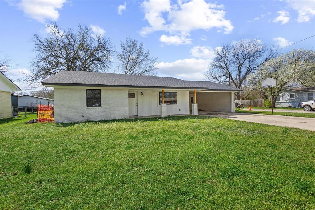 Ranch-style house featuring brick siding, driveway, a carport, and covered porch