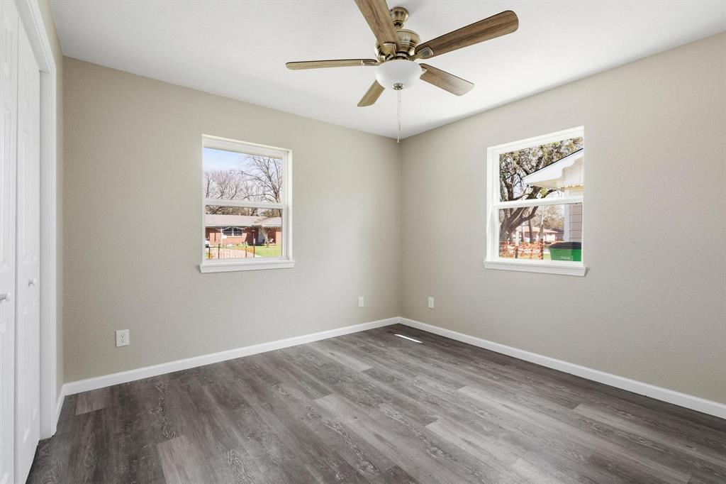 1704 Harris Street Gainesville, TX 76240 - Photo 15 of 21 Unfurnished bedroom featuring a closet, dark wood-style flooring, and ceiling fan