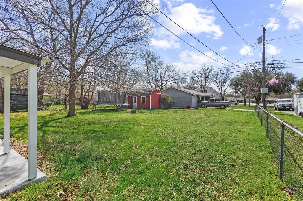 1704 Harris Street Gainesville, TX 76240 - Photo 18 of 21 Fenced backyard with a trampoline and a storage shed