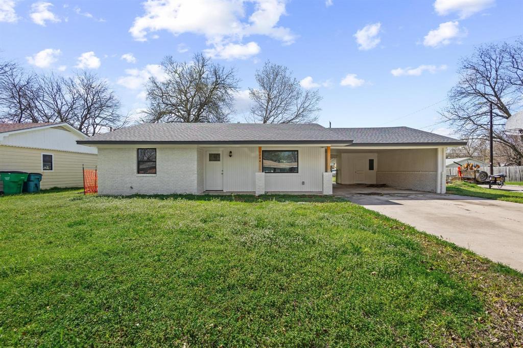 1704 Harris Street Gainesville, TX 76240 - Photo 2 of 21 Single story home featuring a carport, a front yard, and concrete driveway