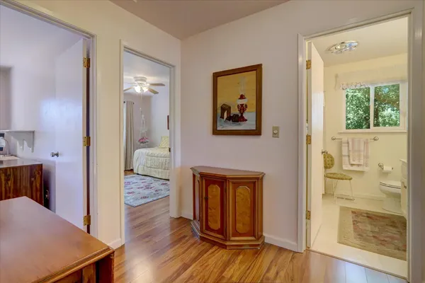 a bedroom with a bed and a television on dresser
