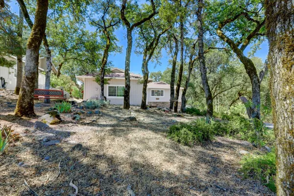 a view of a house with a tree in the background