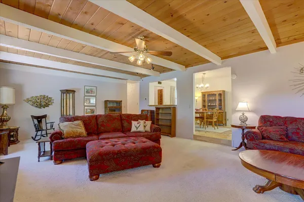 a spacious bedroom with a bed a couch and large windows