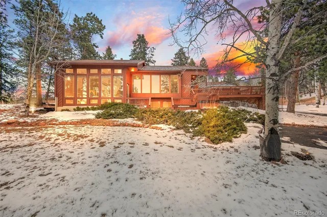 a view of a yard covered with snow in front of house