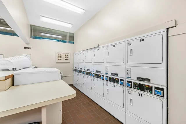 a kitchen with white cabinets and white appliances