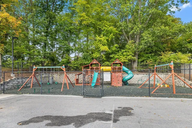 a view of a park with iron fence