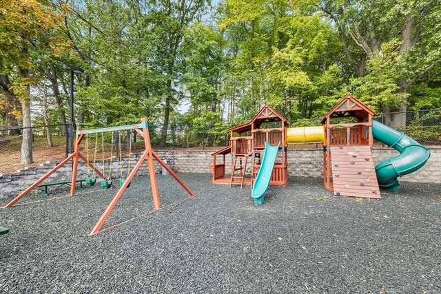 a view of outdoor space with playground and green space