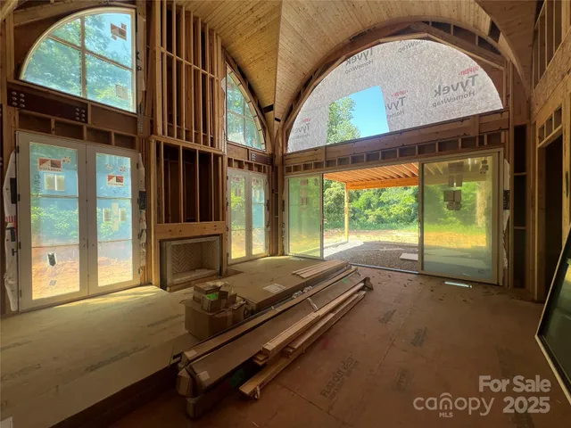 a room with pool table and windows