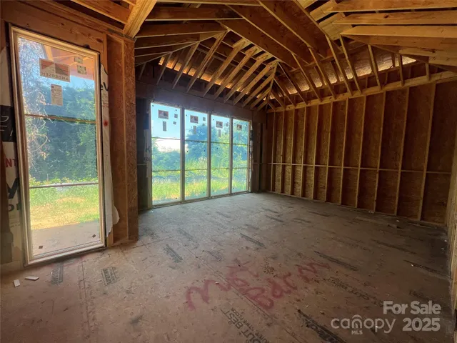a view of a room with wooden floor and windows